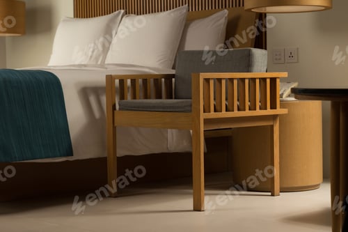 Preview: An elegant bedroom, featuring a wooden chair and a cozy bed, bathed in warm, inviting light.