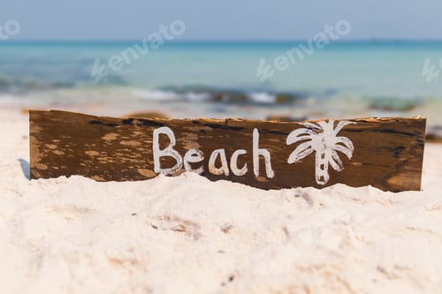 Preview: Wooden sign with lettering on the beach