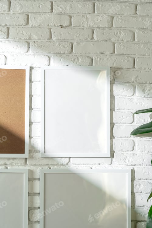 Preview: Varied Sized Photo Frames Displayed on a White Brick Wall