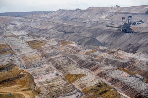 Preview: Wide shot of a mining field with an industrial structure