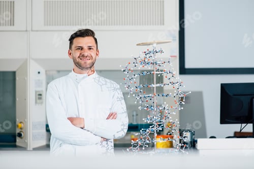 Preview: Confident scientist with arms crossed in modern laboratory