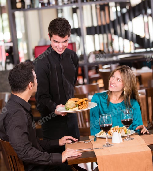 Preview: Happy Couple Eating At A Restaurant And Smiling