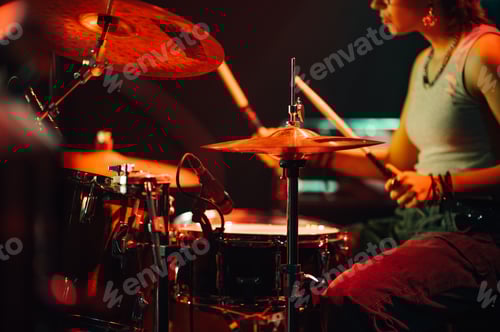Preview: Woman Playing Drums Under Red Stage Lights
