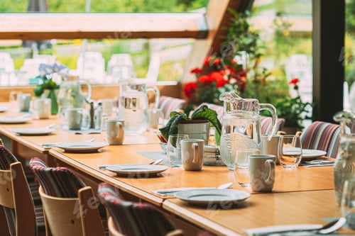 Preview: Cozy Interior Of Summer Cafe. Jug Of Water On Table And Cutlery Laid Out