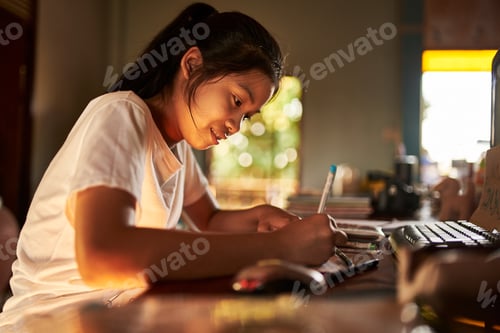 Preview: thai teen girl doing homework and studying at home