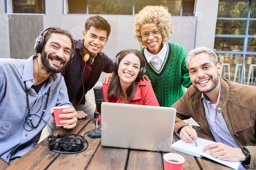 Preview: Portrait looking at the camera of a Group of young smiling people outdoors watching a video