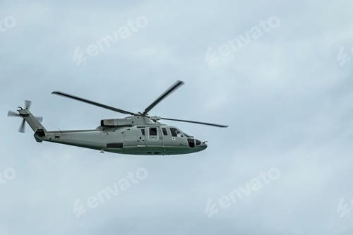 Preview: Military gray navy helicopter flying in the sky