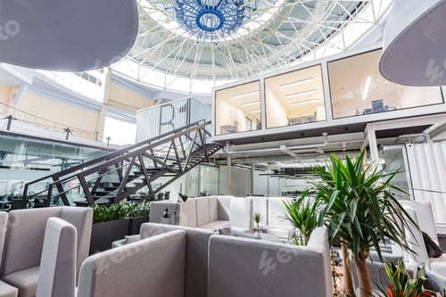 Preview: Interior of modern coworking space with working and rest zones