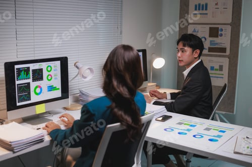 Preview: Business colleagues collaborating on data analysis in office