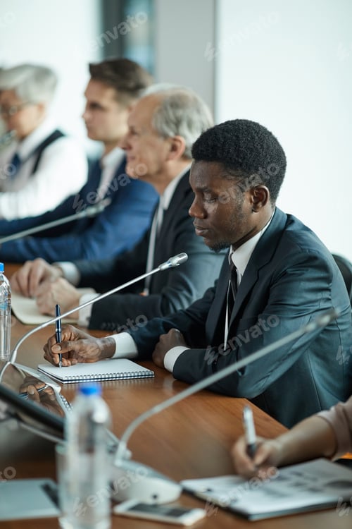 Preview: Businessman writing at conference