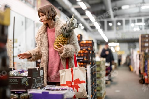 Preview: Woman buying fruits at local indoor market