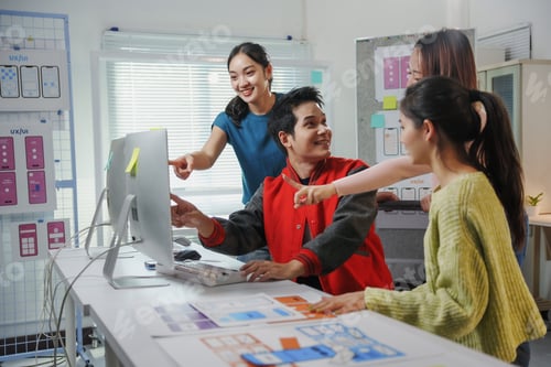 Preview: Asian uxui designers working together pointing at computer screen