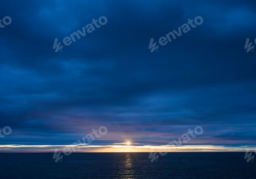 Preview: Sunset over Ocean on a Dark Cloudy Evening