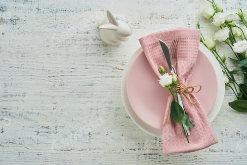 Preview: Easter brunch table setting. Spring Easter holiday concept with white, pink plate and napkin with de