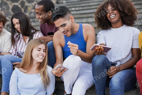 Preview: Group of young multiracial friends enjoy social moment while using mobile phone in the city