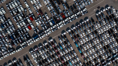 Preview: Aerial top view rows of new cars parked in distribution center on car factory.