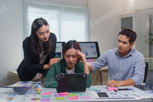 Preview: Stressed businesswoman comforting by colleagues in the office