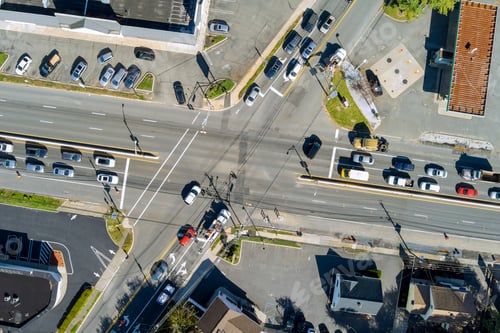 Preview: An aerial view of a road intersection during rush hour with heavy traffic moving on road