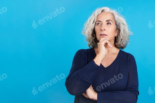 Preview: Mature woman gesturing and looking up with pensive expression