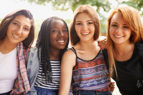 Preview: Four beautiful young girls smiling happinly while they sit outside