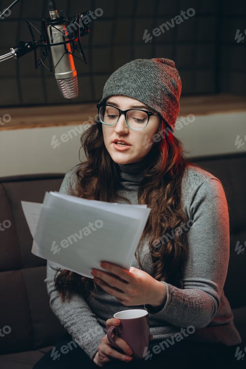 Preview: Woman preparing material before radio show, studio recording.
