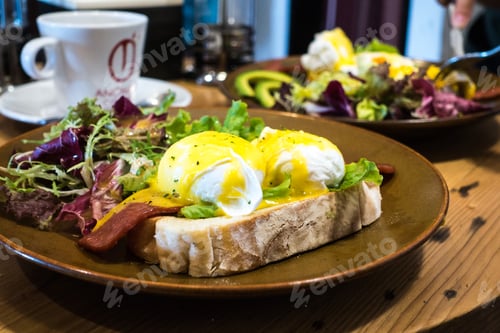 Preview: Delicious poached eggs with bacon on a toasted bread