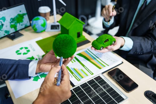 Preview: A meeting at an office desk focuses on teamwork with a house model and discussions on electric cars