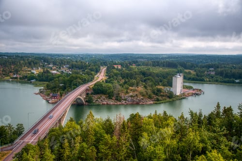 Preview: Aerial view of a bridge with cars driving on it over the Baltic Sea in Finland under a cloudy sky