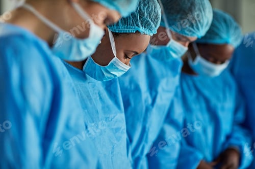 Preview: Cropped shot of a group of surgeons performing a medical procedure in an operating room
