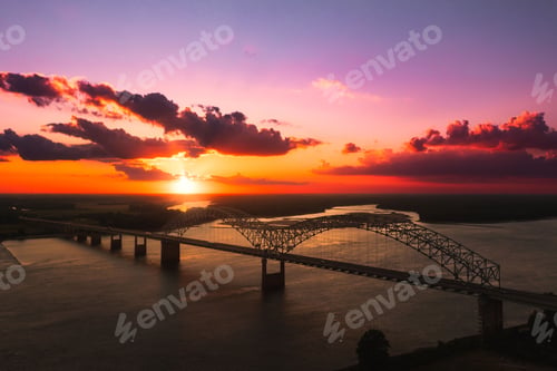 Preview: Bird's eye view of Memphis Bridge connecting Tennessee and Arkansas at sunset over Mississippi River