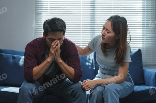 Preview: Young woman comforting her sad husband at home