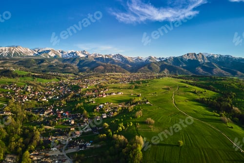 Preview: Aerial view of Tatra mountains and Zakopane town at sunset
