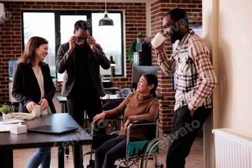 Preview: Diverse team of colleagues laughing in business office