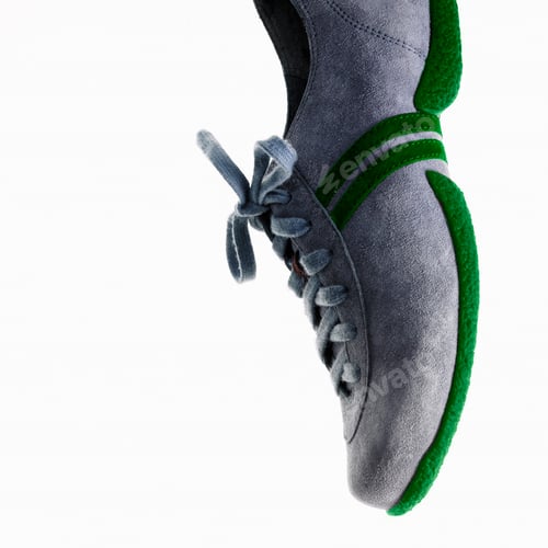 Preview: A single sneaker or trainer shoe with laces and green sole.