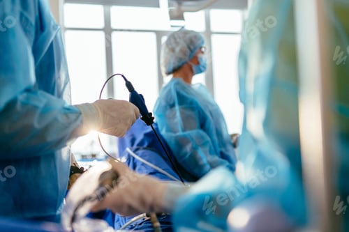 Surgeons Operate Using Endoscopic Technology in Operating Room