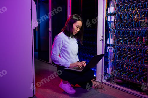 Preview: Asian data center engineer using laptop