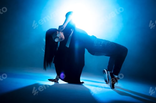 Preview: Trendy young woman dancing single in club, neon light, lots of smoke.