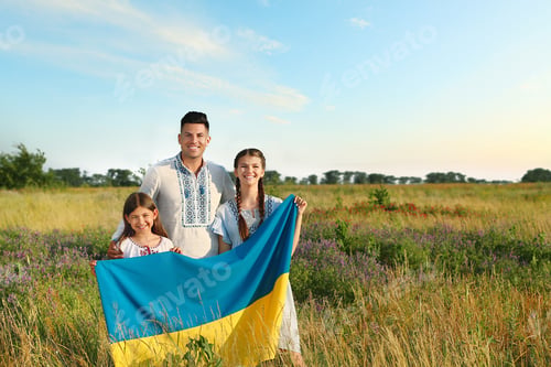 Preview: Family holding national flag of Ukraine in field. Space for text