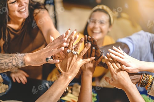 Preview: Adult friends high five at dinner