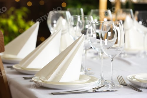 Preview: Table setting with empty glasses, plates and cutlery indoors