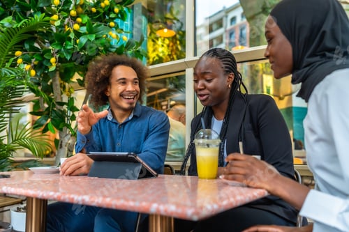 Preview: Diverse friends discussing ideas during a casual cafe meeting