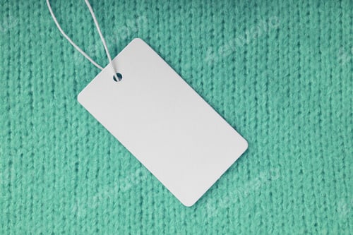 Preview: Template Of Blank Clothing Label, Price Tag On Green Knitted Sweater Background