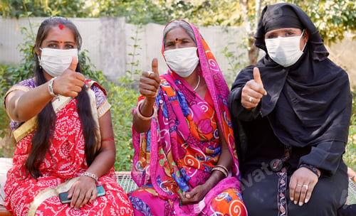 Preview: Closeup of three Indian women posing outdoors with thumbs up