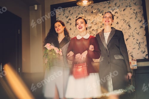 Preview: Three elegant young ladies ready for a party