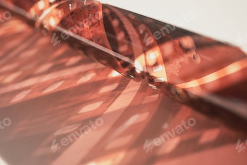 Preview: Close-up view of curled 35mm film negative evoking nostalgia and cinematic art