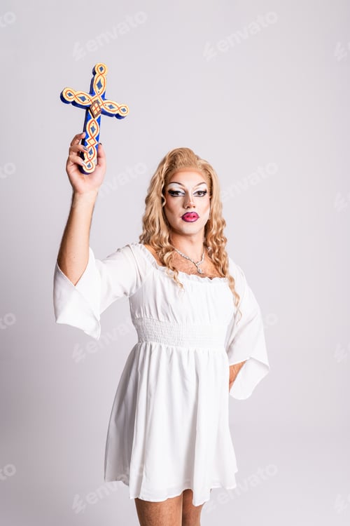 Preview: Drag Queen Proudly Holding a Cross During a Creative Performance in a Studio Setting