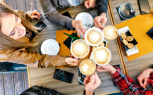 Preview: Top view of friends toasting cappuccino at coffee shop restaurant