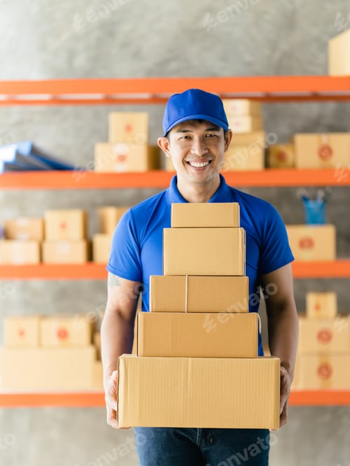 Preview: An Asian delivery man is working inside a warehouse. Delivery and service concept