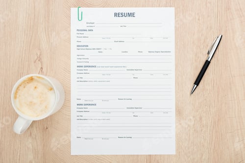Preview: top view of pen and cup of cappuccino with foam near resume template on wooden surface