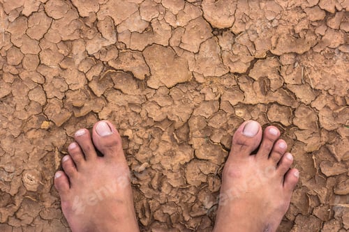 Preview: Naked human barefeet on dry soil